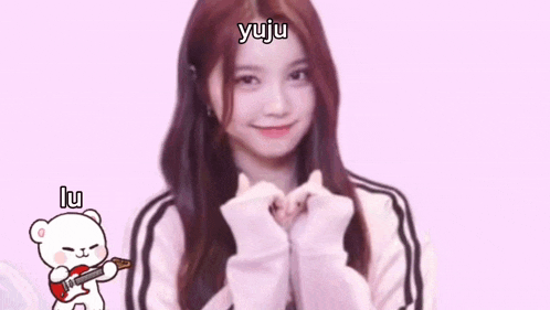 a girl is making a heart shape with her hands and a cartoon bear is holding a guitar .