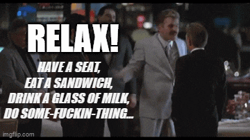 a man in a suit says relax have a seat eat a sandwich drink a glass of milk