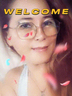 a woman wearing glasses is surrounded by petals and the words welcome are above her