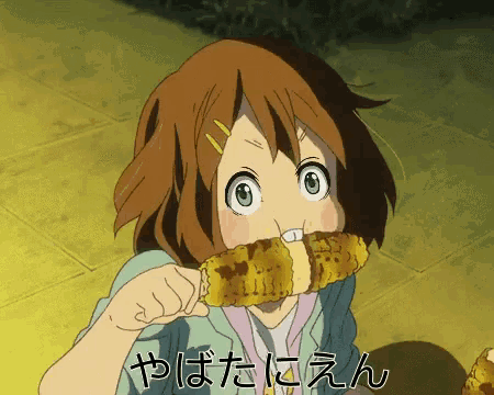 a girl is eating corn on the cob with chinese writing on the bottom right