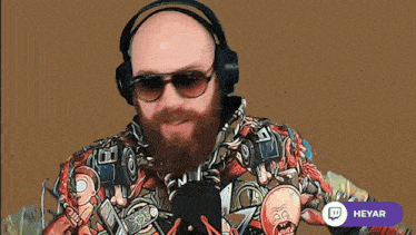a man with a beard wearing headphones and a shirt that says heyar on the bottom