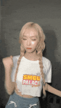 a girl wearing a smcu palace shirt dancing
