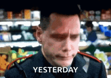 a man in a uniform says yesterday in front of a grocery store aisle