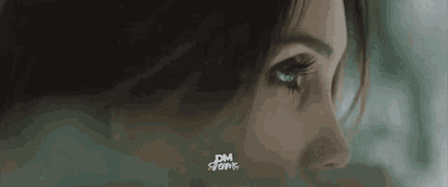 a close up of a woman 's face with a nose ring on it .