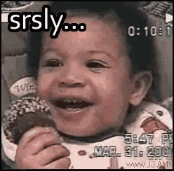 a baby is smiling while holding an ice cream cone in his hands .
