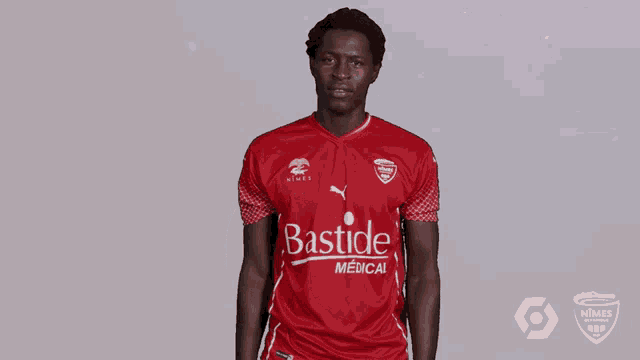 a man in a red bastide medical shirt