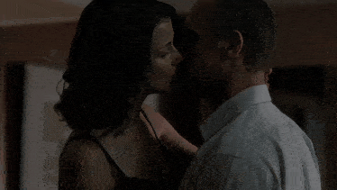 a man and a woman kissing in the dark
