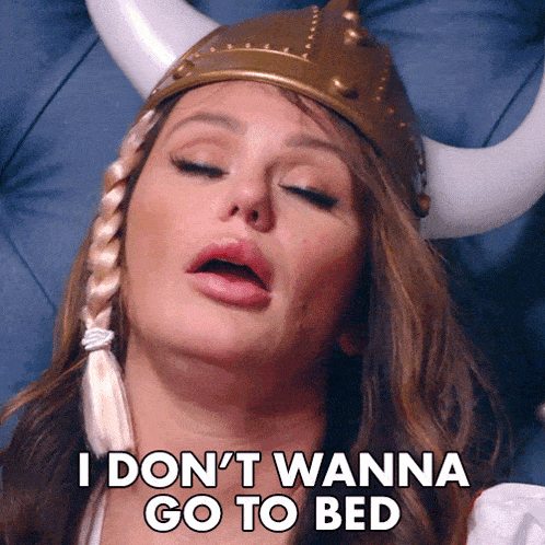 a woman wearing a viking hat says " i don 't wanna go to bed "