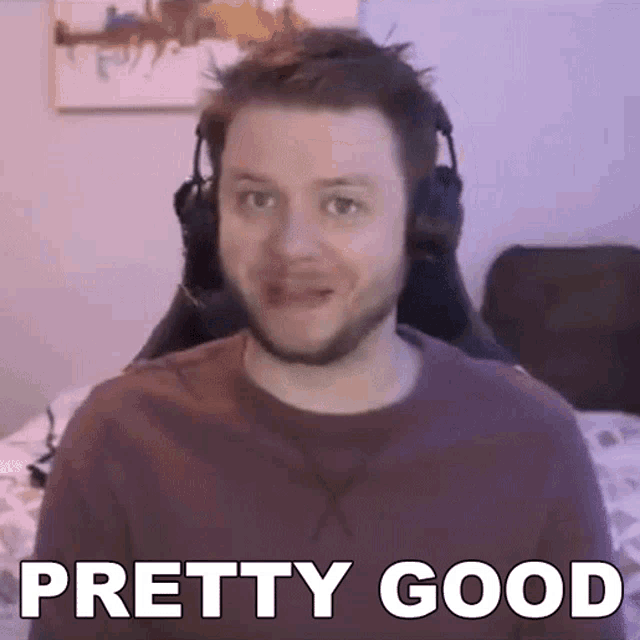 a man wearing headphones is sitting in a chair and making a face .