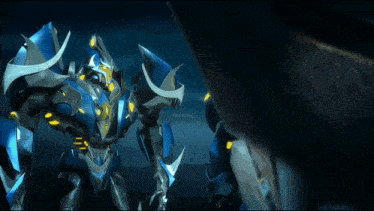 a blue robot with yellow lights on it 's arms