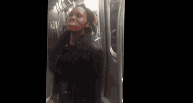 a blurred image of people on a train with a red sign that says ' exit '