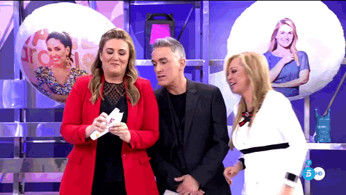 a woman in a red jacket is holding a piece of paper that says " love "