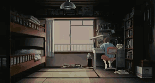 a man sits at a desk in a dark room