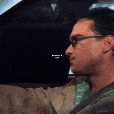 a man wearing glasses is driving a car with a screen that says runforce come