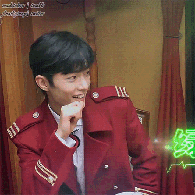 a man in a red uniform is eating a piece of food