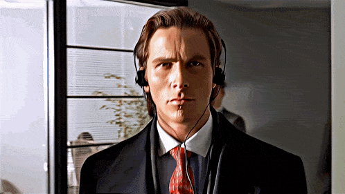 a man in a suit and tie is wearing a pair of headphones