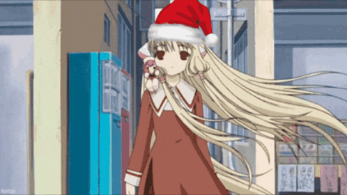 a girl in a santa hat is talking on a cell phone