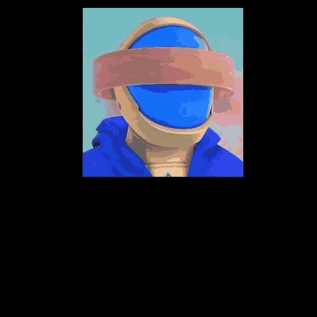 a close up of a person wearing a blue helmet and a blue shirt .