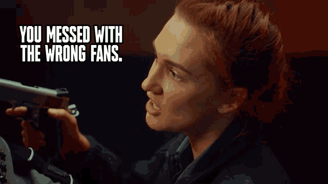 a woman holding a gun with the words " you messed with the wrong fans " below her