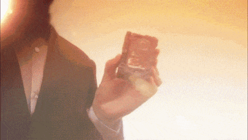 a man in a suit is holding a card that says ' aa ' on it