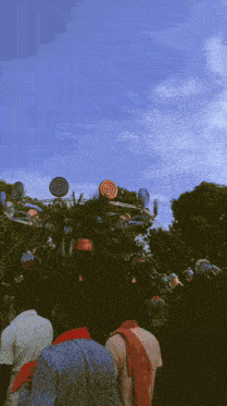 a bunch of people are riding a carousel with lollipops on it