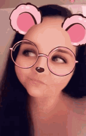 a woman wearing pink glasses with a mouse face on her face