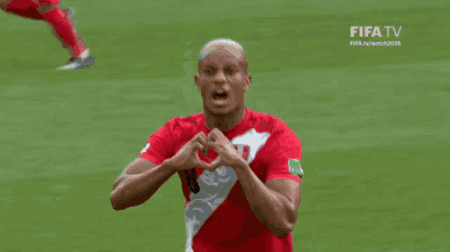 a soccer player wearing a red and white shirt with the number 18 on it