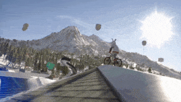a person is riding a bike on a snowy hill