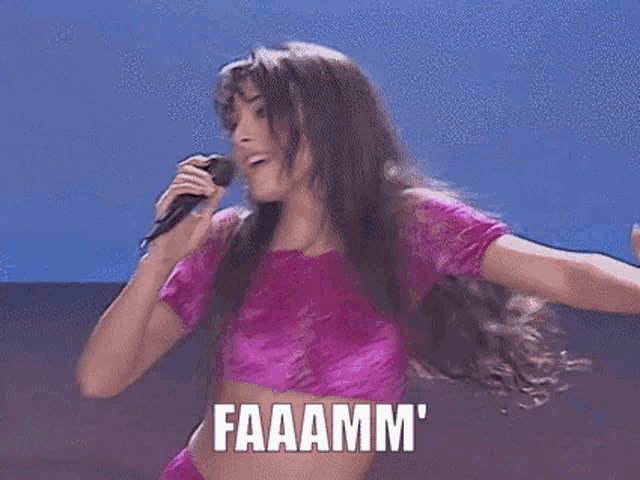 a woman in a purple shirt is holding a microphone and the words addurmiii are above her