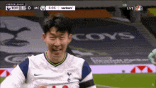 a soccer player with the word coys on the field behind him