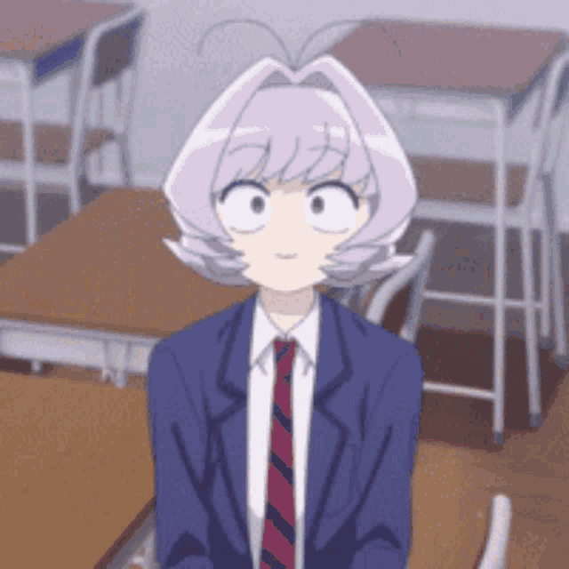 a girl with purple hair is sitting at a desk in a classroom