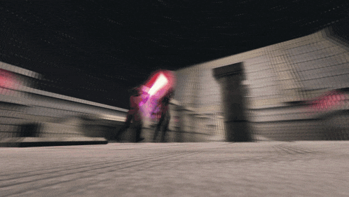 a blurry picture of a person holding a purple light saber