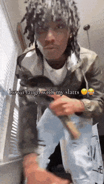 a man with dreadlocks is standing in front of a window with the caption how i laugh with my slatts .
