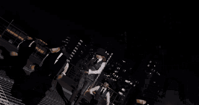 a group of men are dancing on a metal surface