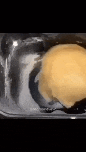 a close up of a bowl of food with a spoon in it .