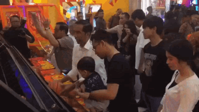 a group of people are playing a game with a man wearing a t-shirt that says " avengers "