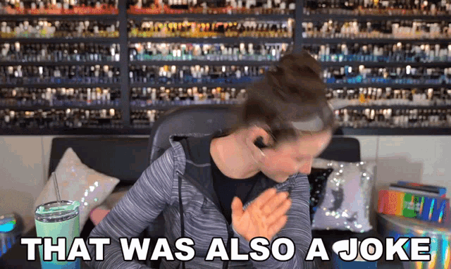 a woman says that was also a joke in front of a wall full of bottles