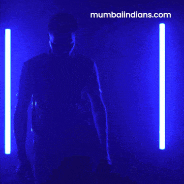 a man wearing a blue shirt that says mumbai indians