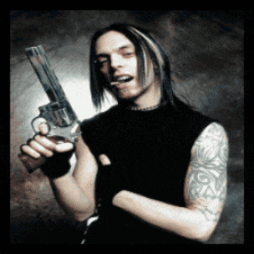 a man with long hair and a tattoo on his arm holds a gun