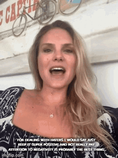 a woman is making a funny face with a caption that says for dealing with haters i would say just