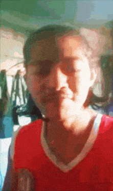 a girl wearing a red and white jersey with the letter a on it