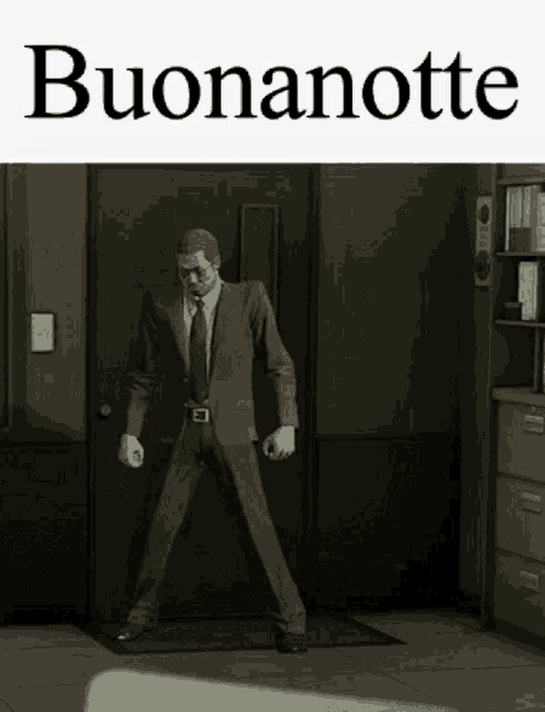 a man in a suit and tie is standing in front of a door with the words buonanotte written above him