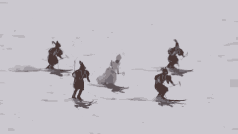 a group of people are skiing down a snow covered slope