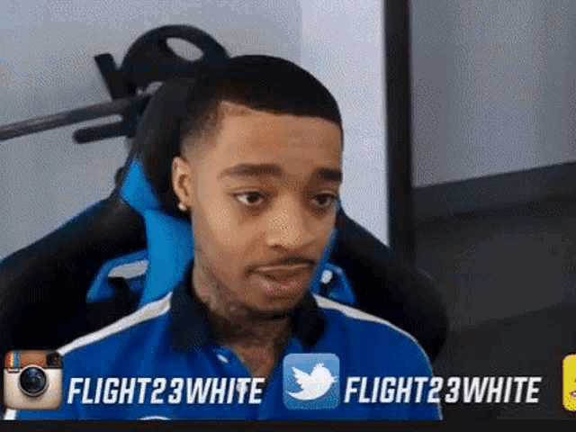 a man in a blue shirt is sitting in a chair with twitter and instagram icons behind him .