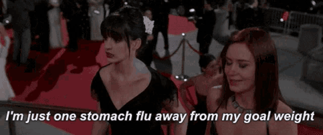two women standing on a red carpet with the words i 'm just one stomach flu away from my goal weight
