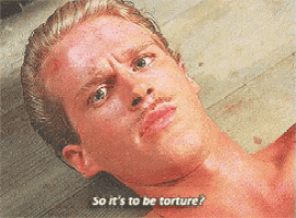 a man with a mustache is laying on the floor with the words so it 's to be torture