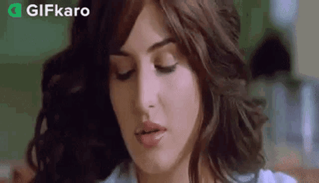 a close up of a woman making a funny face with her eyes closed .