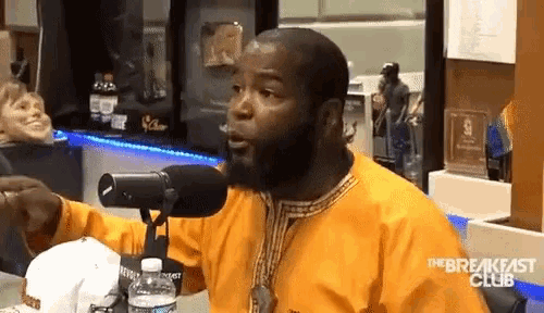 a man with a beard is talking into a microphone with the breakfast club written on the bottom