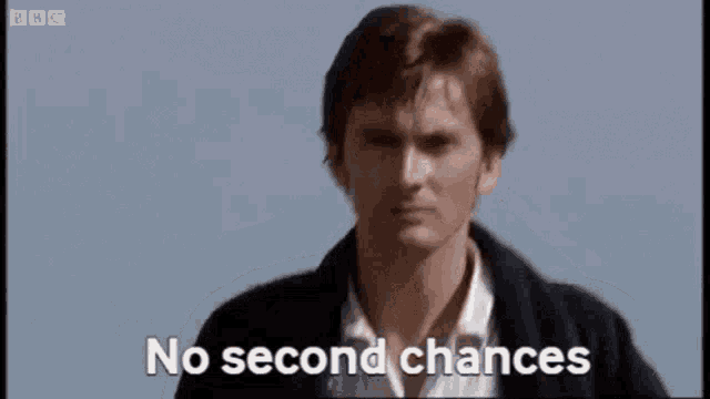 a man is standing in front of a blue sky with the words `` no second chances '' written on the screen .