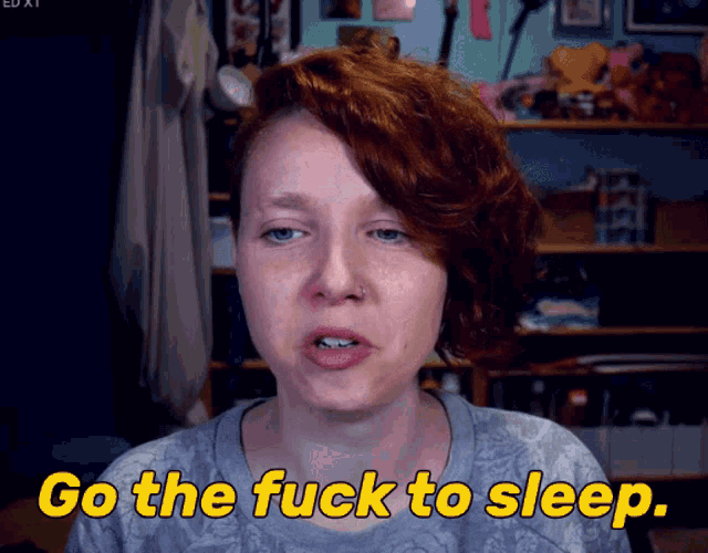 a woman with red hair says go the fuck to sleep in yellow letters
